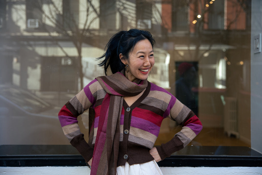 Atardecer Alpaca Cardigan — striped alpaca knit in earthy brown, taupe, crimson, and violet, inspired by Andean sunsets.