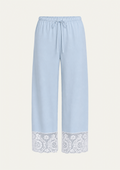 Light blue wide-leg pants with a drawstring waist and a white lace trim at the hem, shown against a plain off-white background.