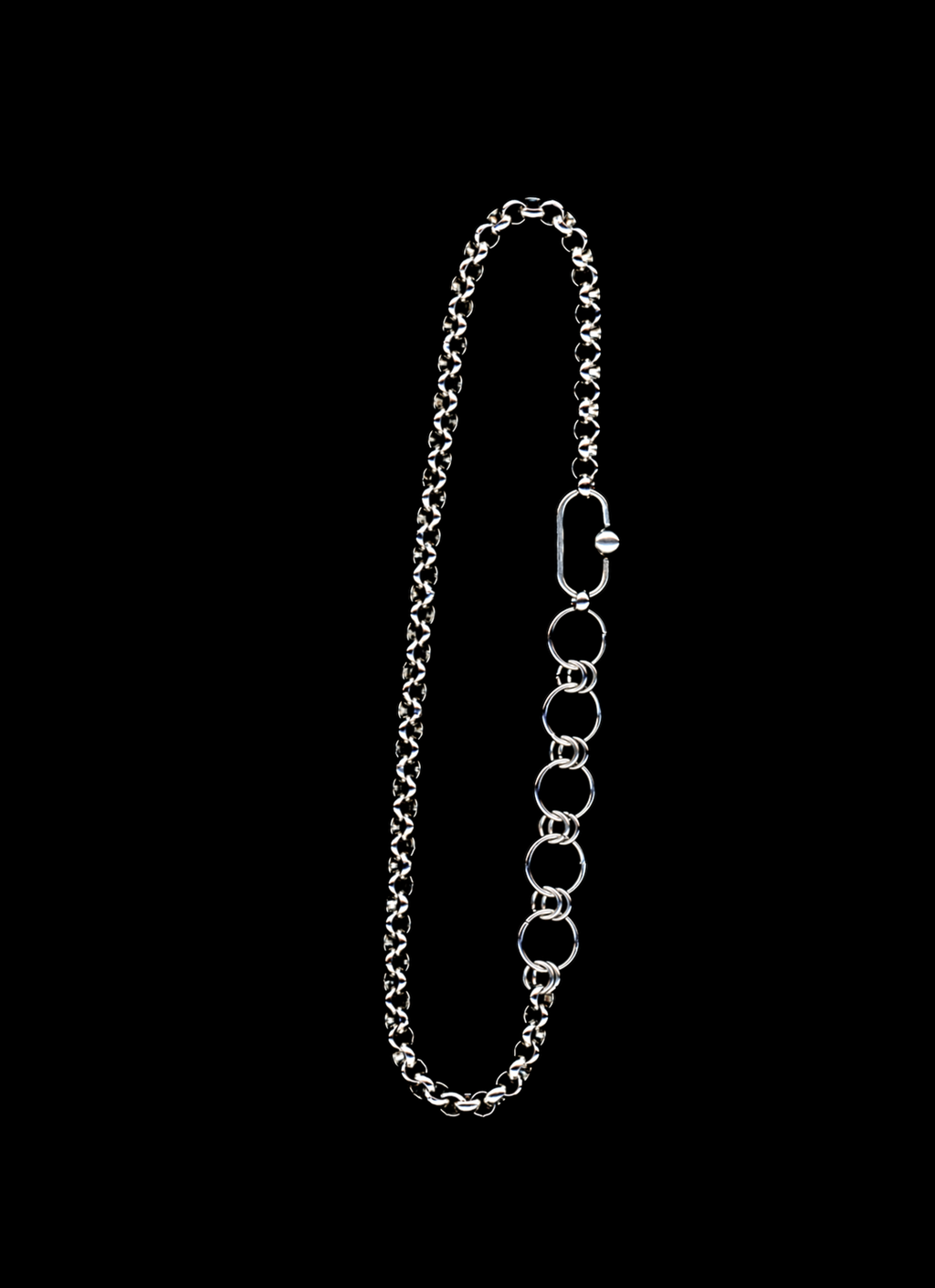 Stainless steel chain necklace with orbit carabiner and chainmail detail on a black background
