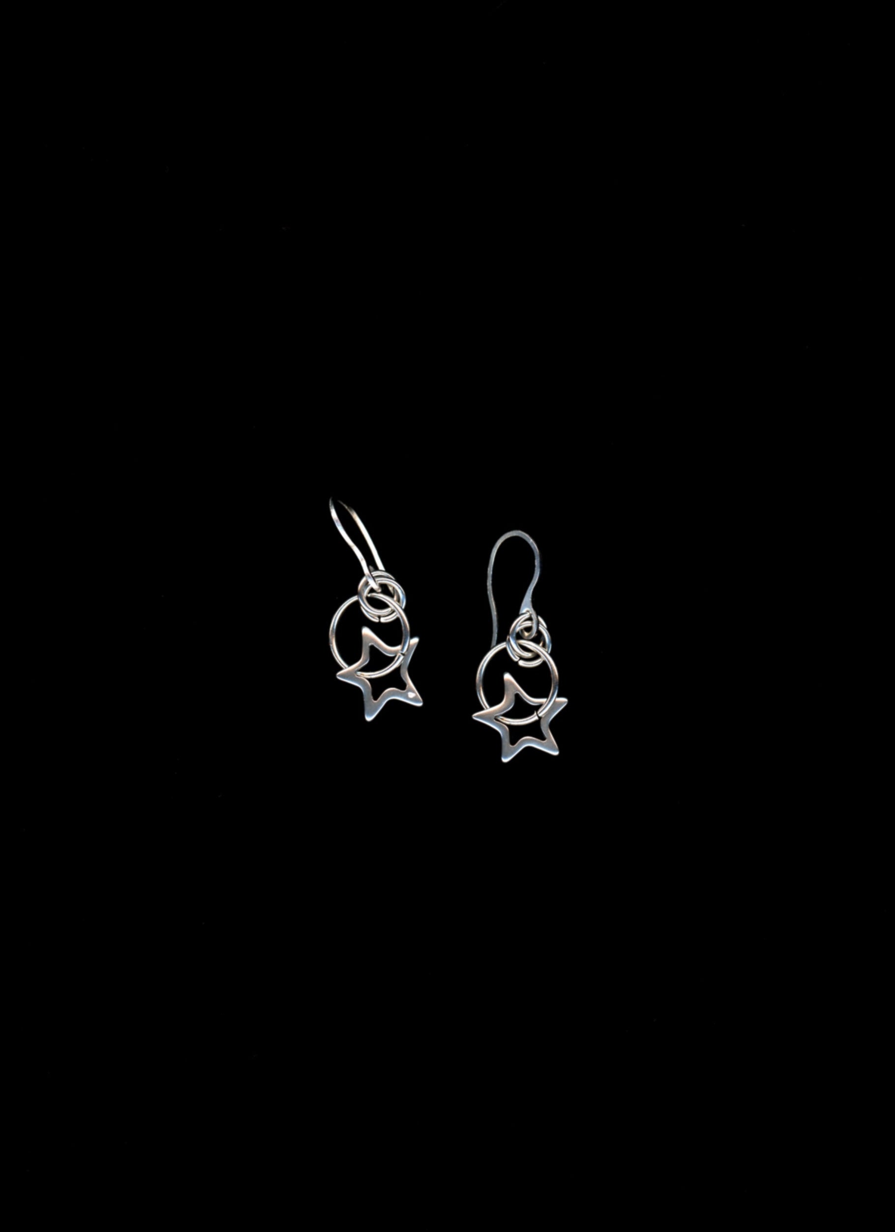 Star-shaped earrings on a black background