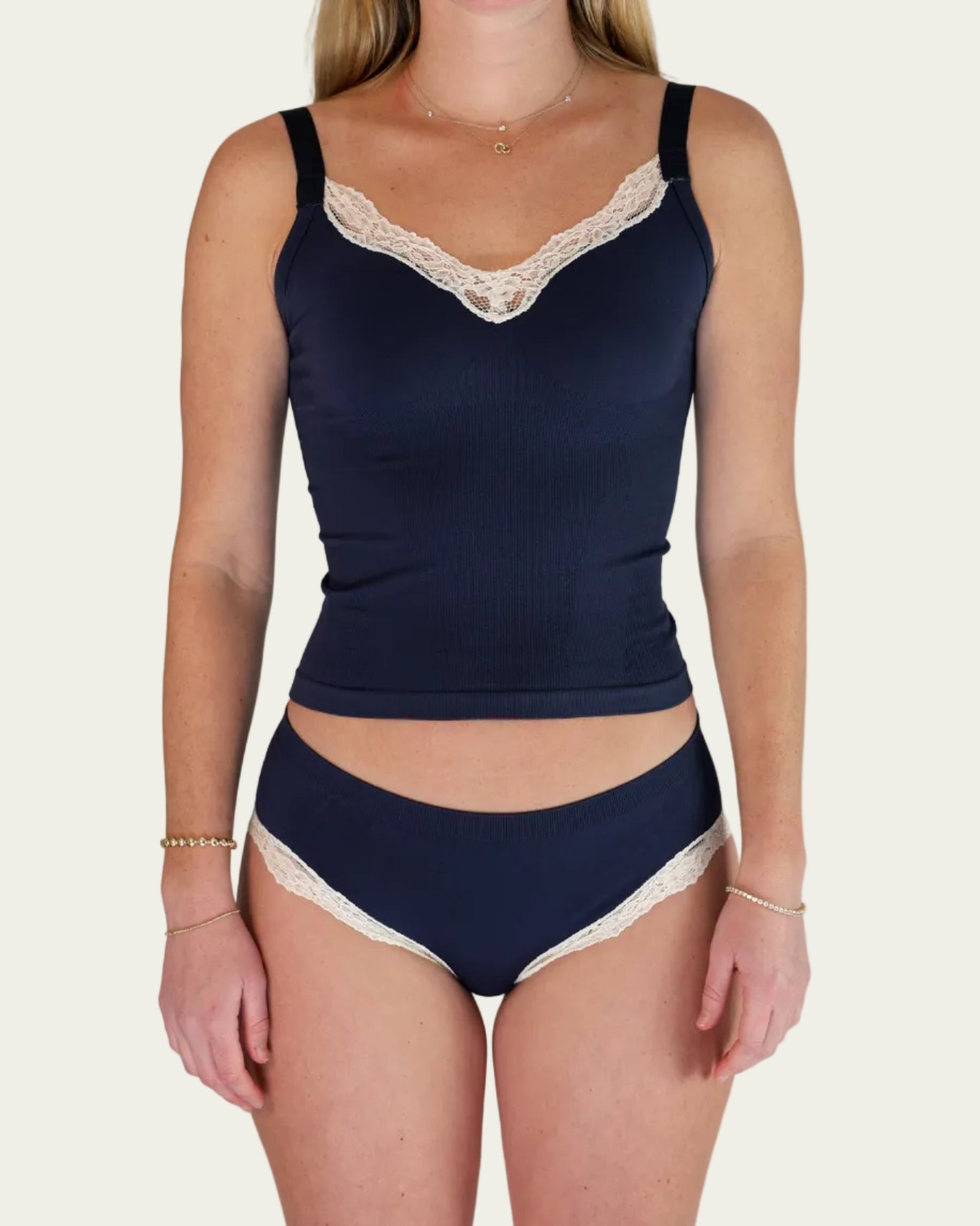 Front view of model wearing the Lunetti Luna Top and Luna Brief in Midnight Navy with white lace trim.