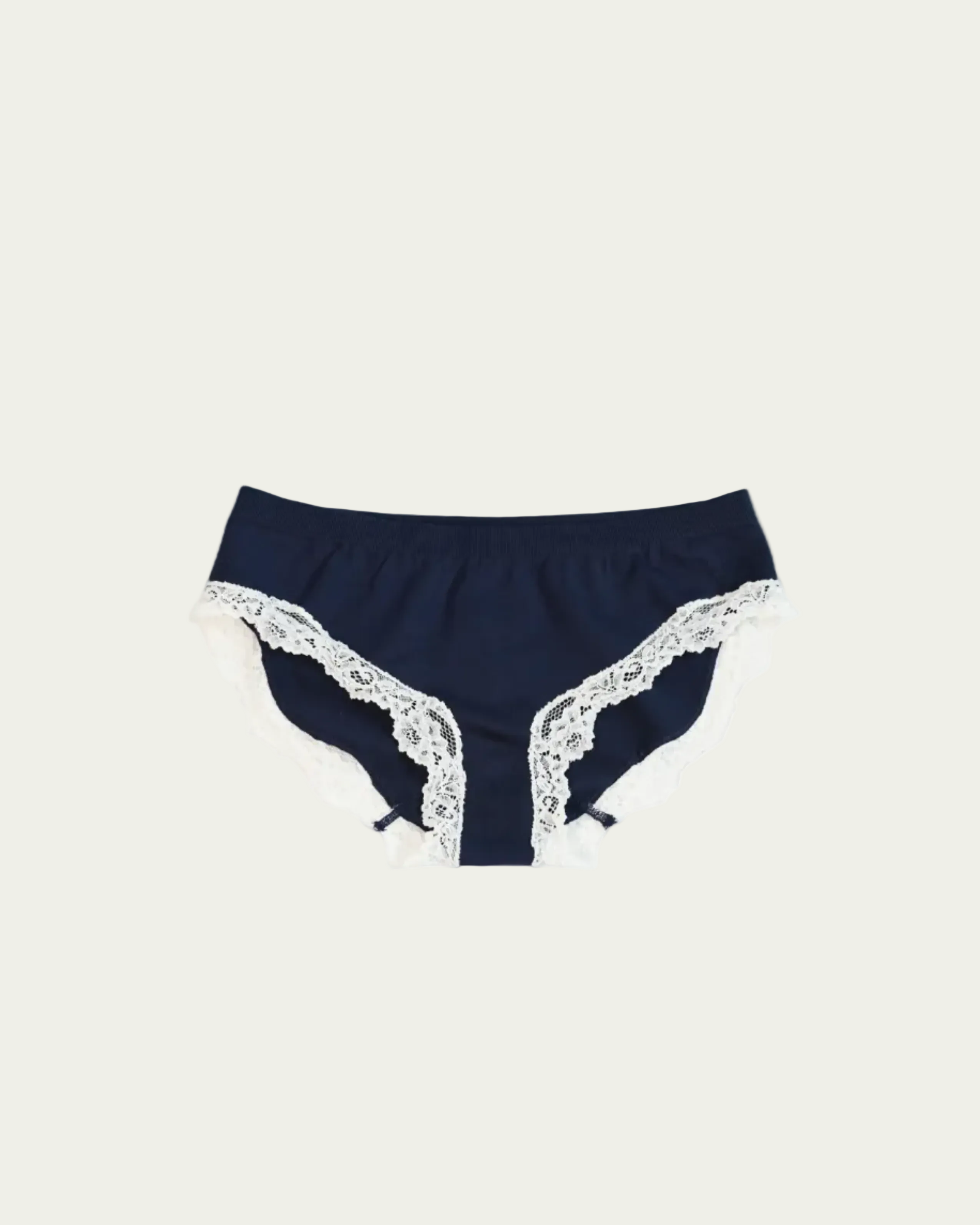 Flat lay front view of the Lunetti Luna Brief in Midnight Navy with white lace trim.