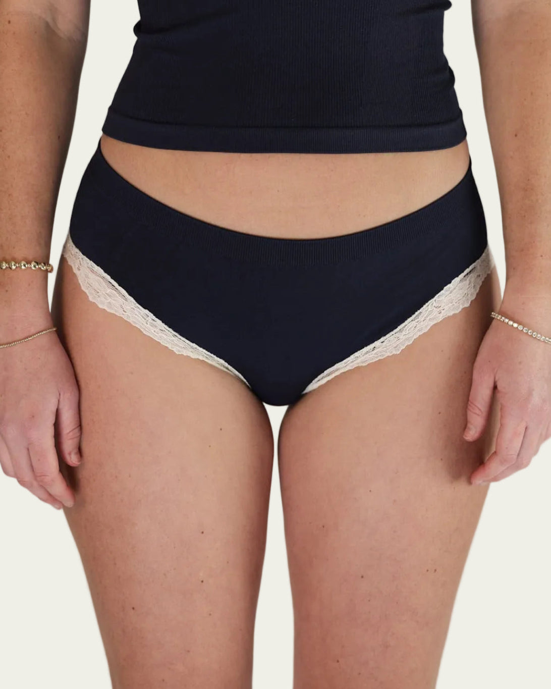 Front view of the Lunetti Luna Brief in Midnight Navy with white lace trim.