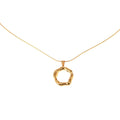Gold necklace with a unique pendant on a white background