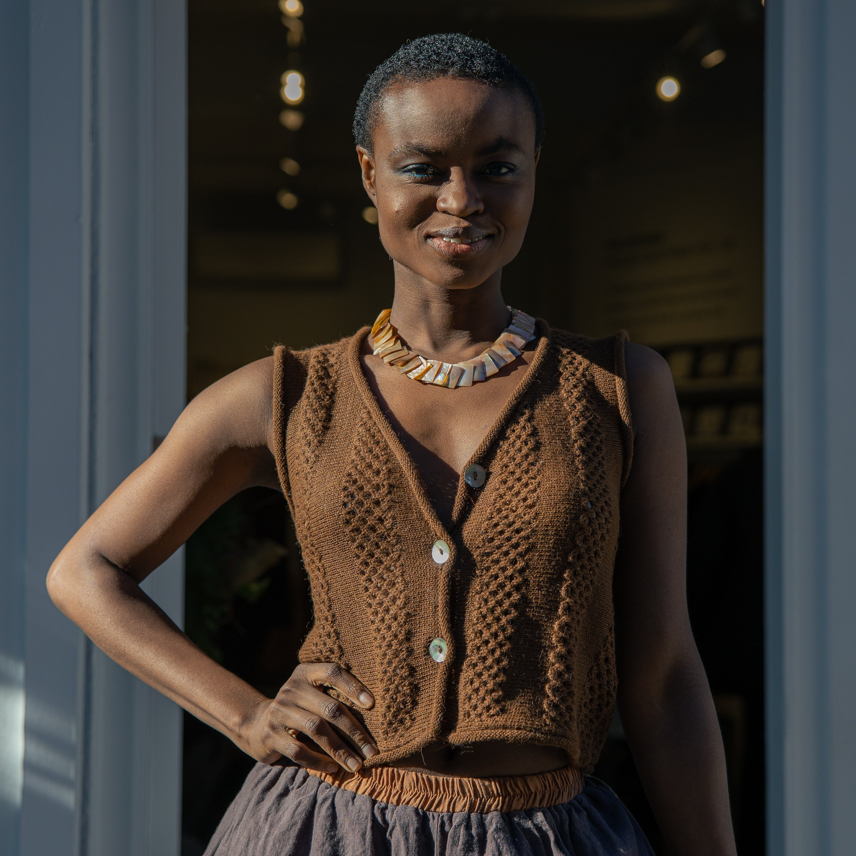 Panti Alpaca Vest — hand-crocheted alpaca vest with openwork stitch, crystal or mother-of-pearl buttons, artisan-made in Bolivia.