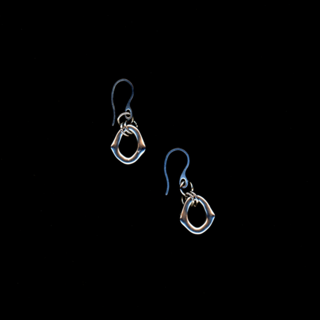 Pair of stainless steel 'portal' earrings on a black background